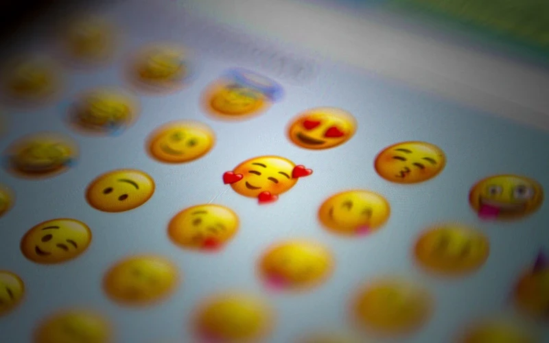 A photo of a phone screen showing a selection of emoji faces
