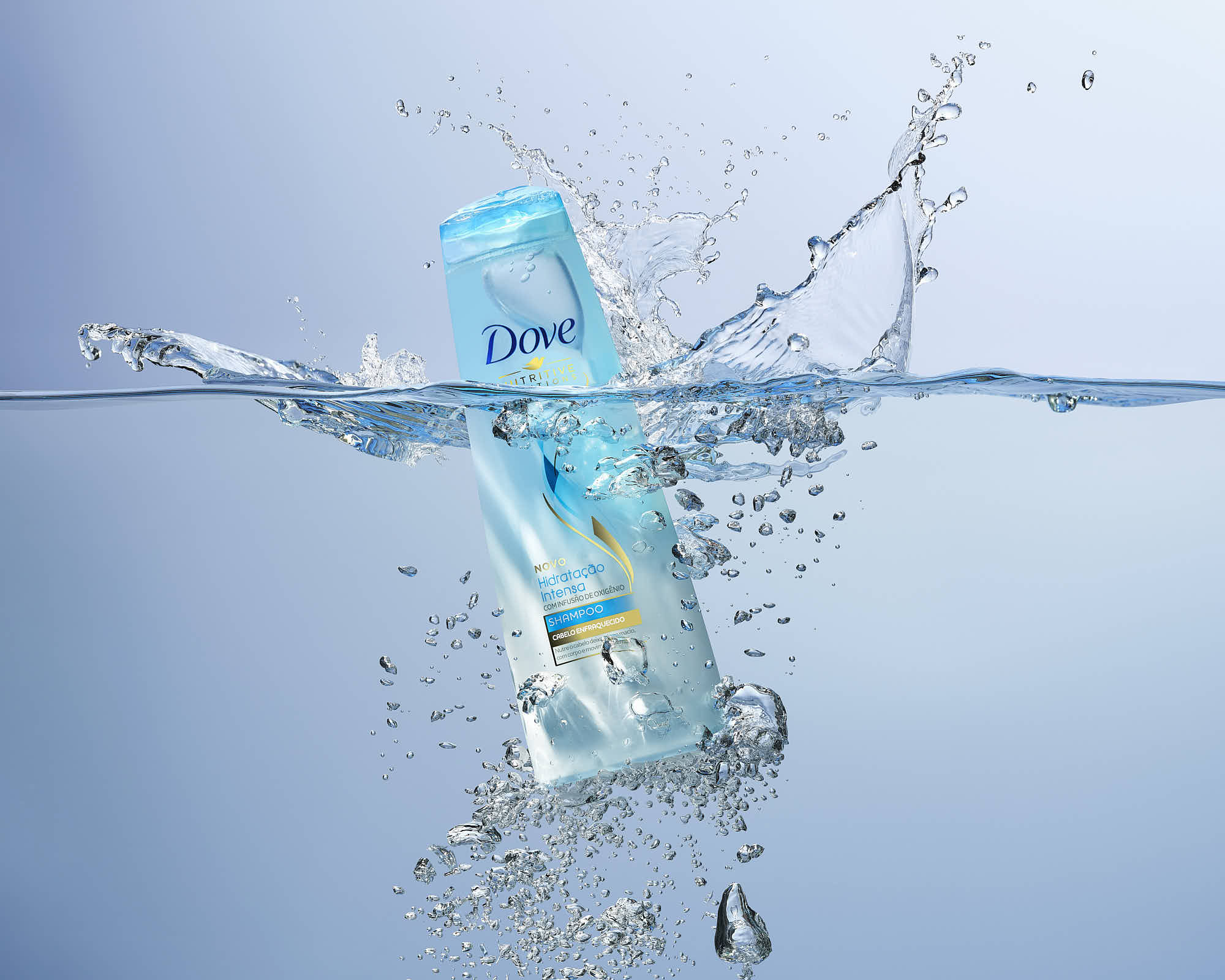 A clear bottle submerged in water, creating splashes and bubbles around it.