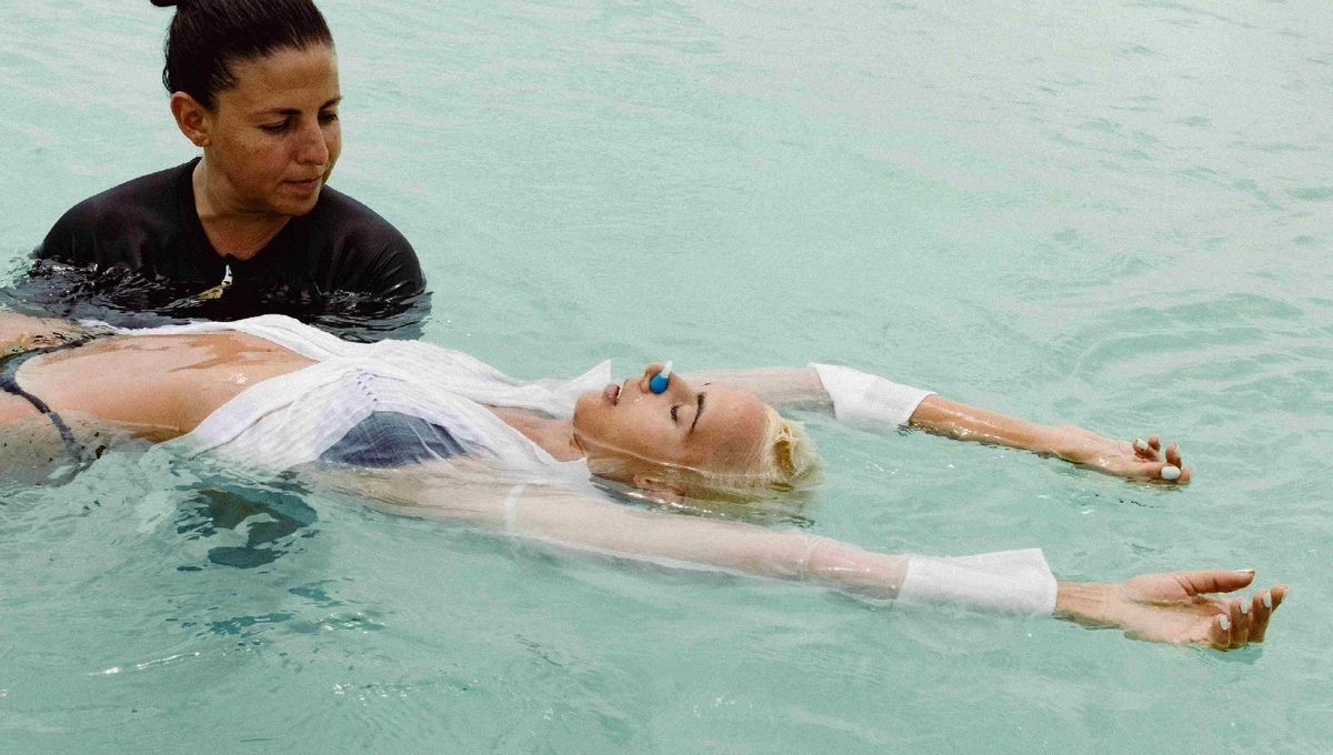 Unique ocean swimming yoga session offered by Nomade Holbox in Holbox Mexico, with clear blue waters and white sand beaches