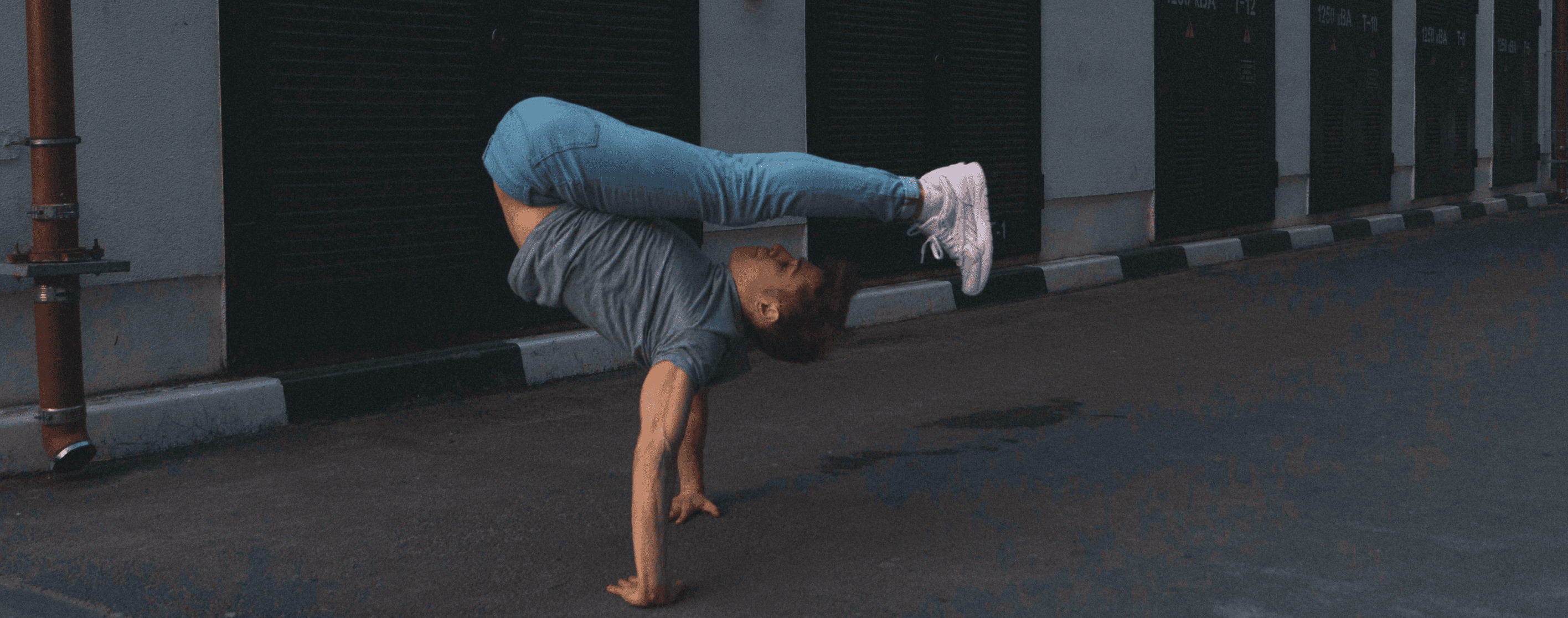 A man is performing a handstand, symbolizing flexibility – Celeri offers flexible payroll payments.