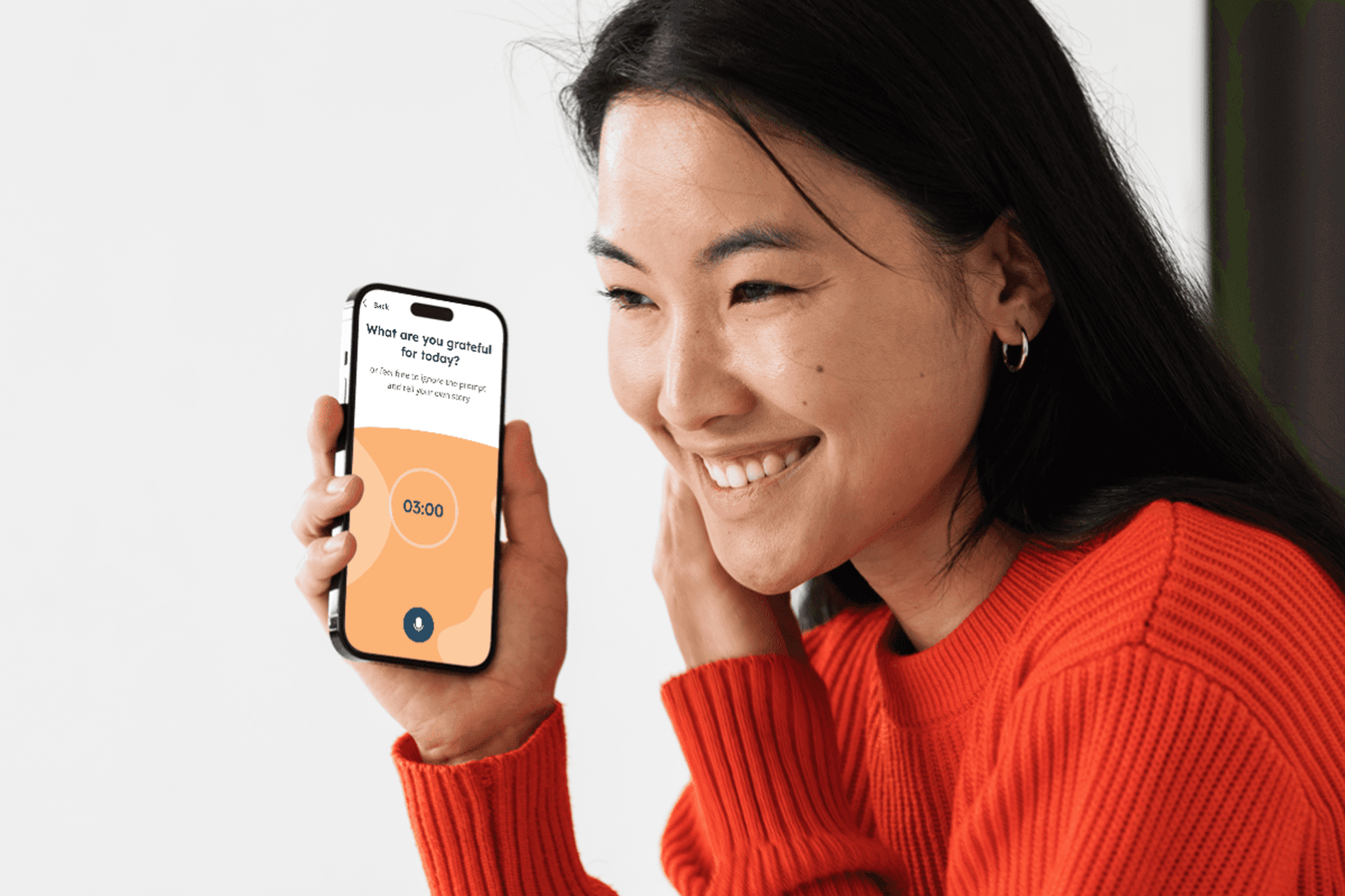 A woman holding her mobile phone recording on the Polaraud app