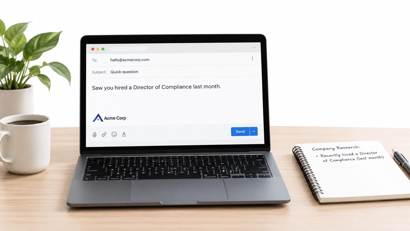 A laptop on a desk showing an email drafted to Acme Corp about their new compliance hire.