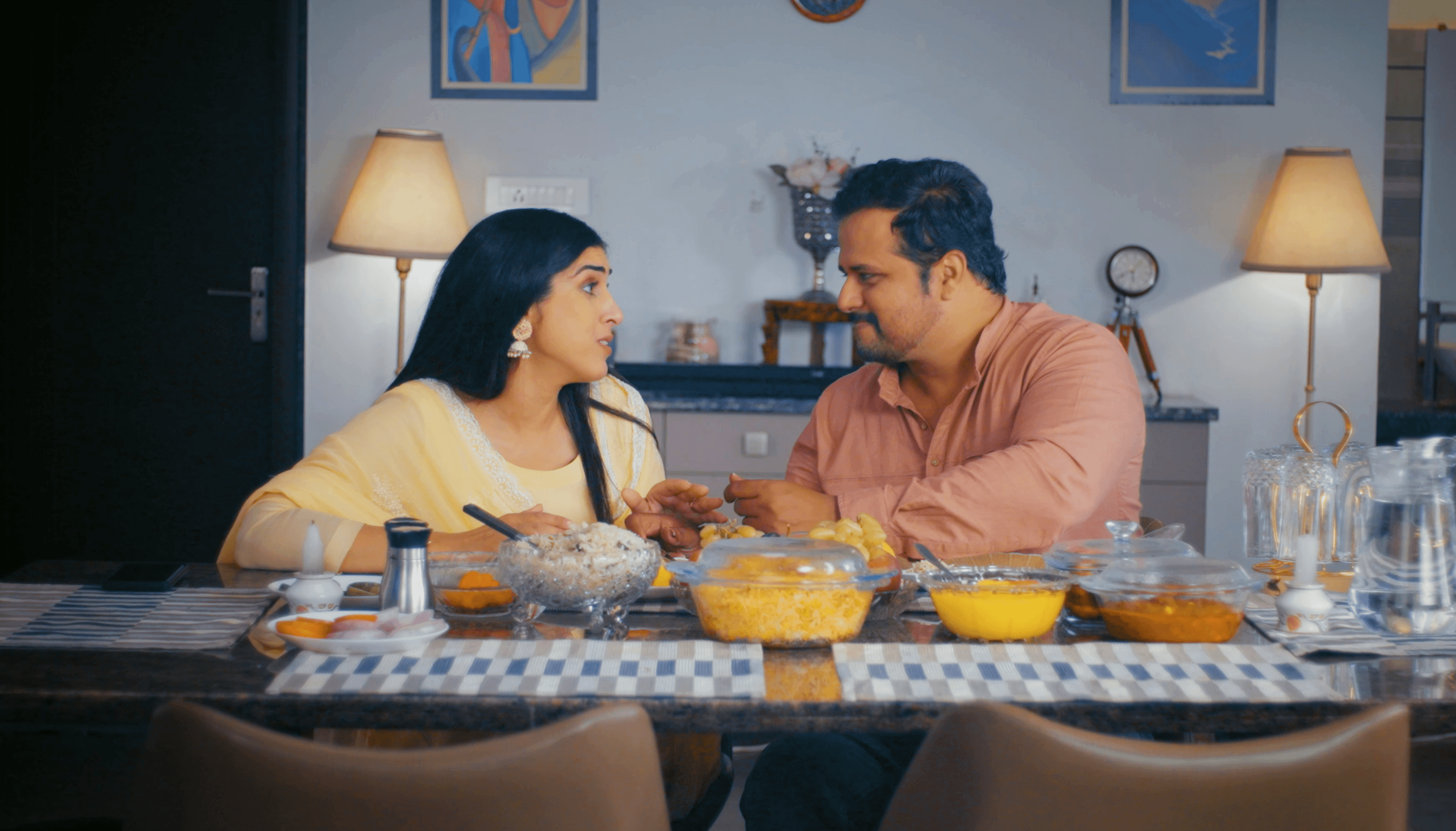 Couple sharing a meal at home in an ad film for Hungersate.