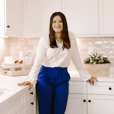 Woman in pink sweater indoors.