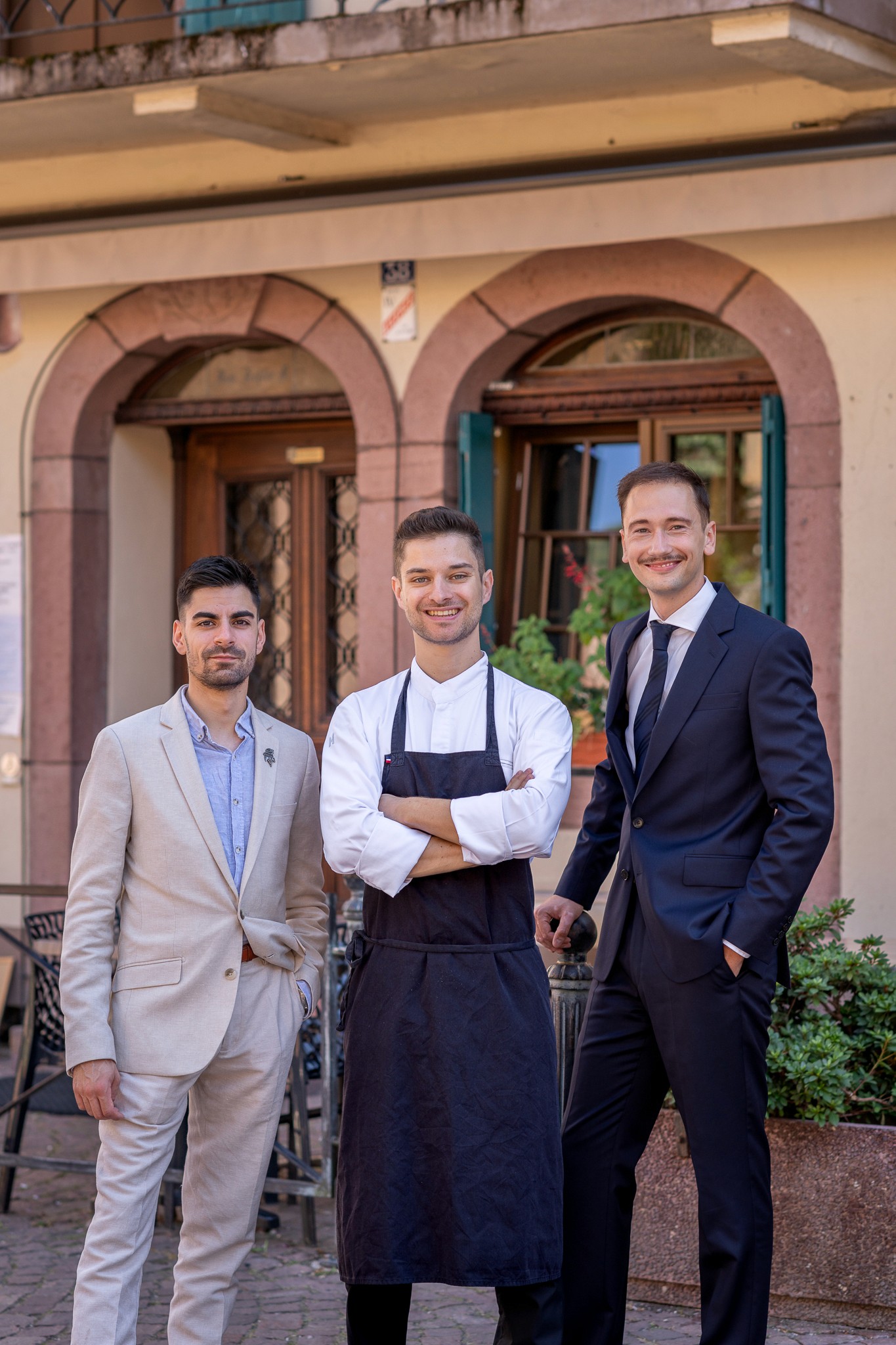Restaurant bar with guests seated at tables and bartenders at work.