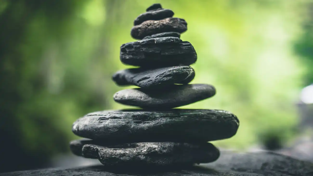 Stacked stones balancing in nature, illustrating the need for proportionate value, fair pricing and clear deliverables in sports sponsorship agreements.