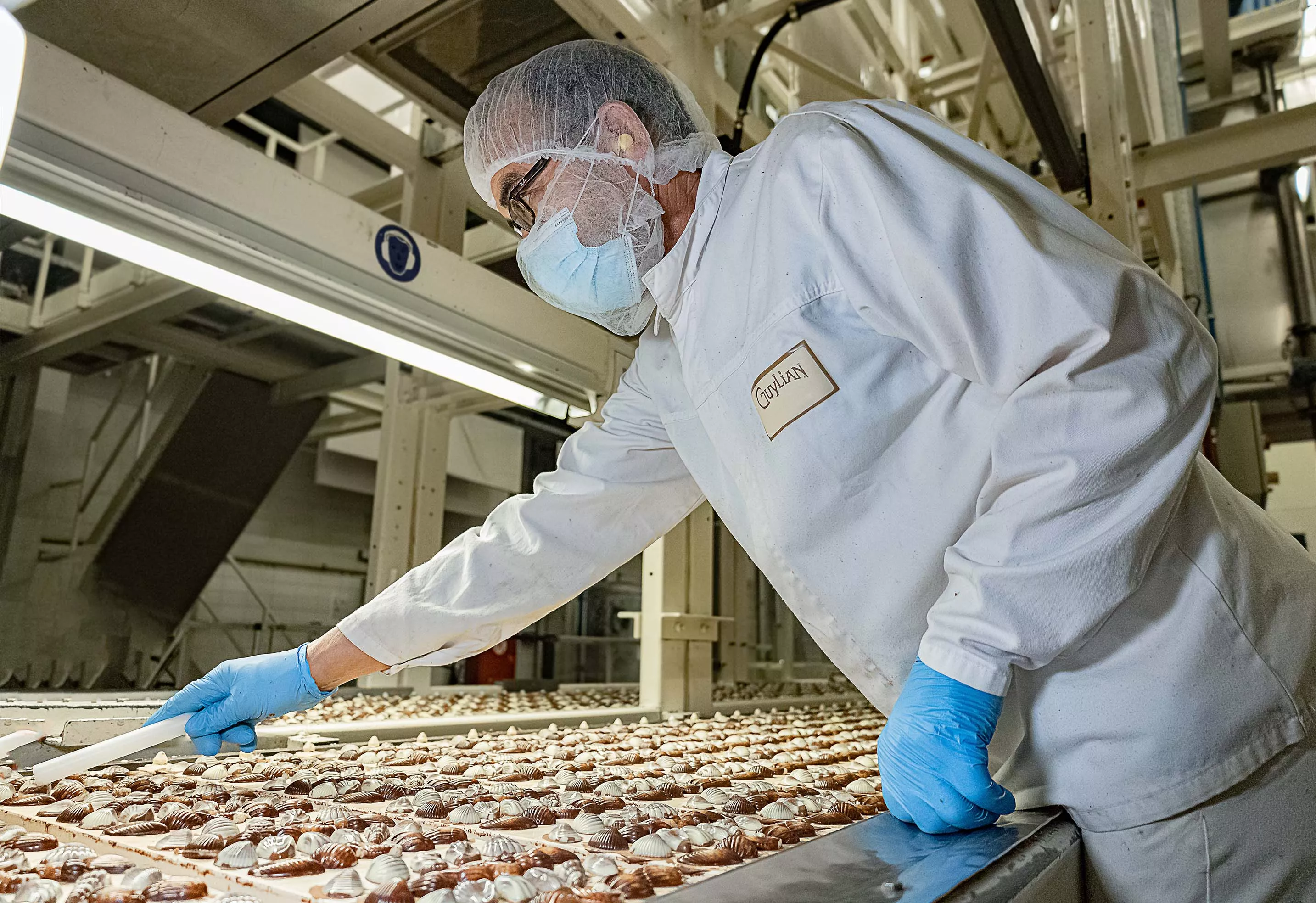 woman in black blazer sitting on concrete bench during daytime