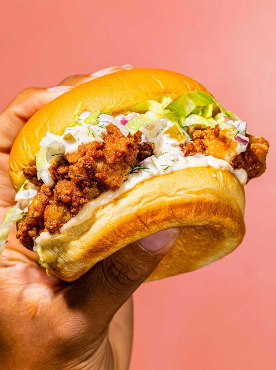 A cluttered dining table with plates, glasses, and food remnants, illuminated by soft, warm lighting.