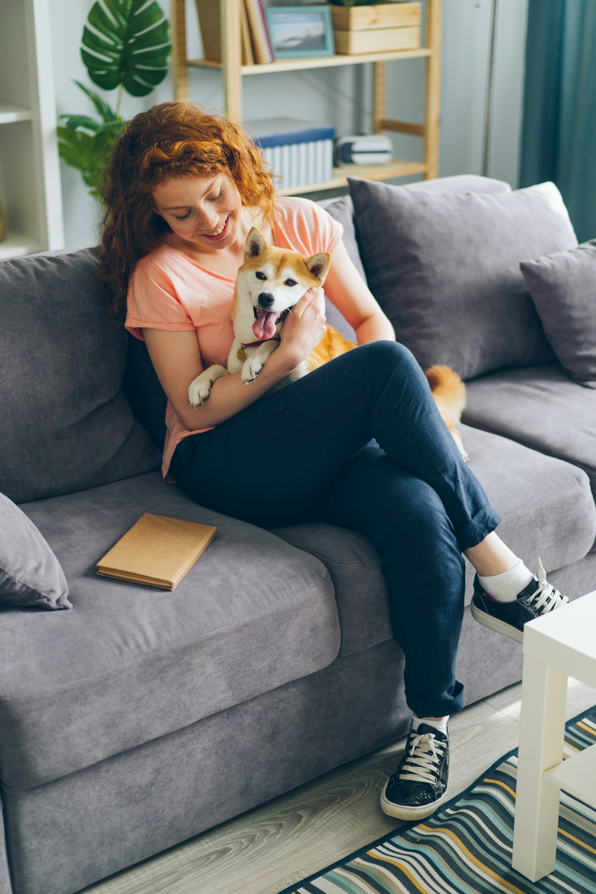 Woman relaxing on the sofa with her dog