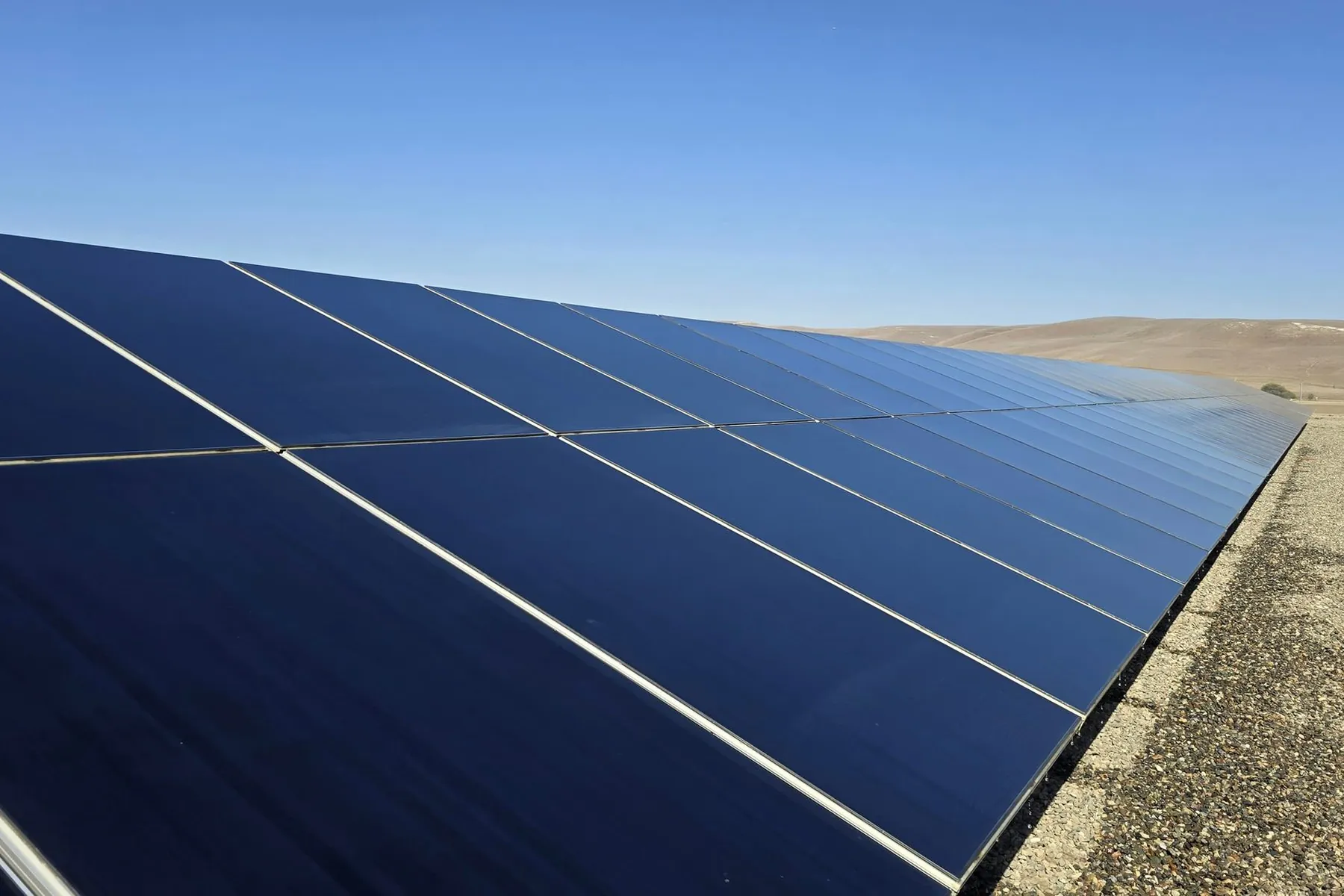 Ground-mount solar row with clean, deep blue glass after a wash