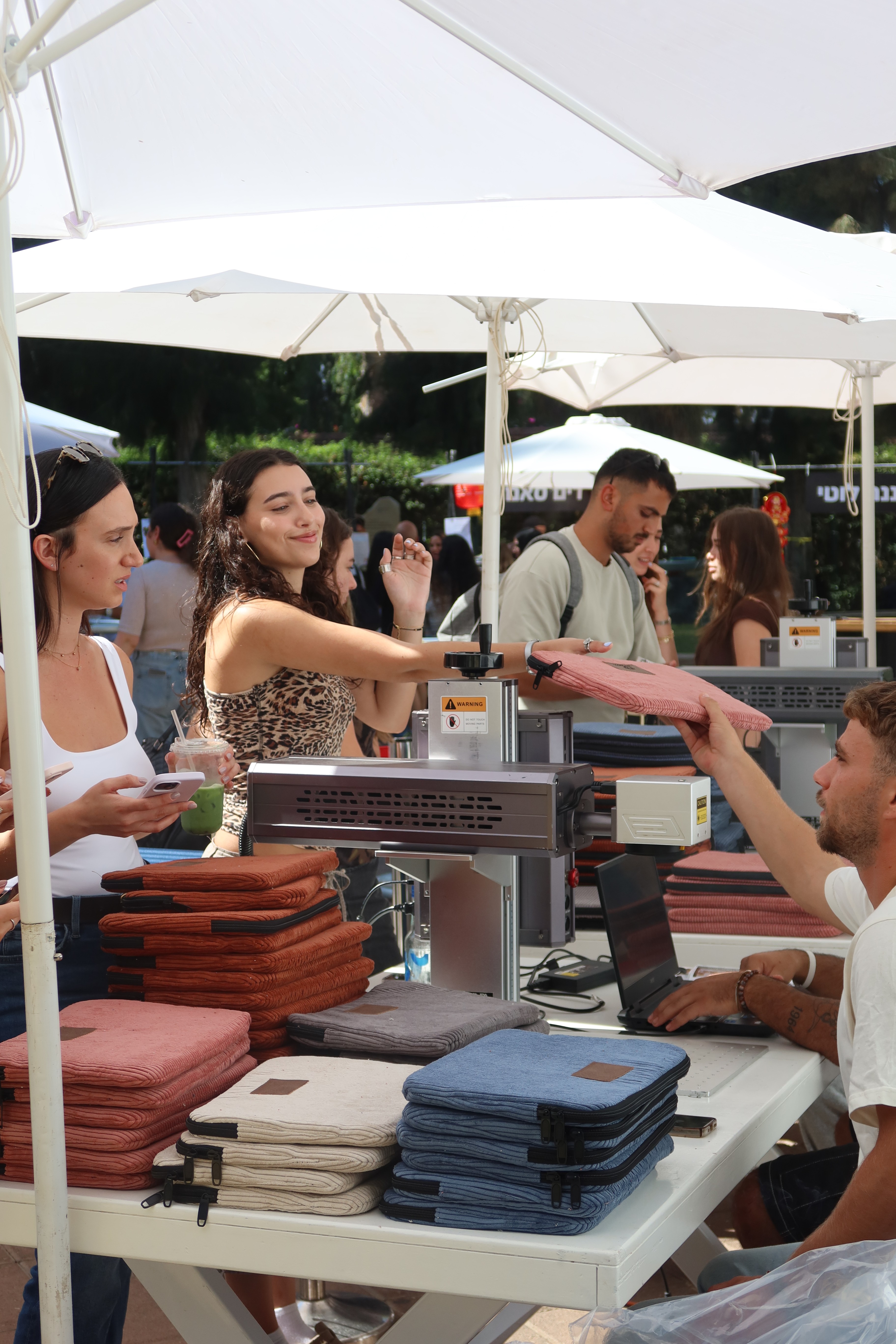 Guests choosing merchandise and watching it personalized live