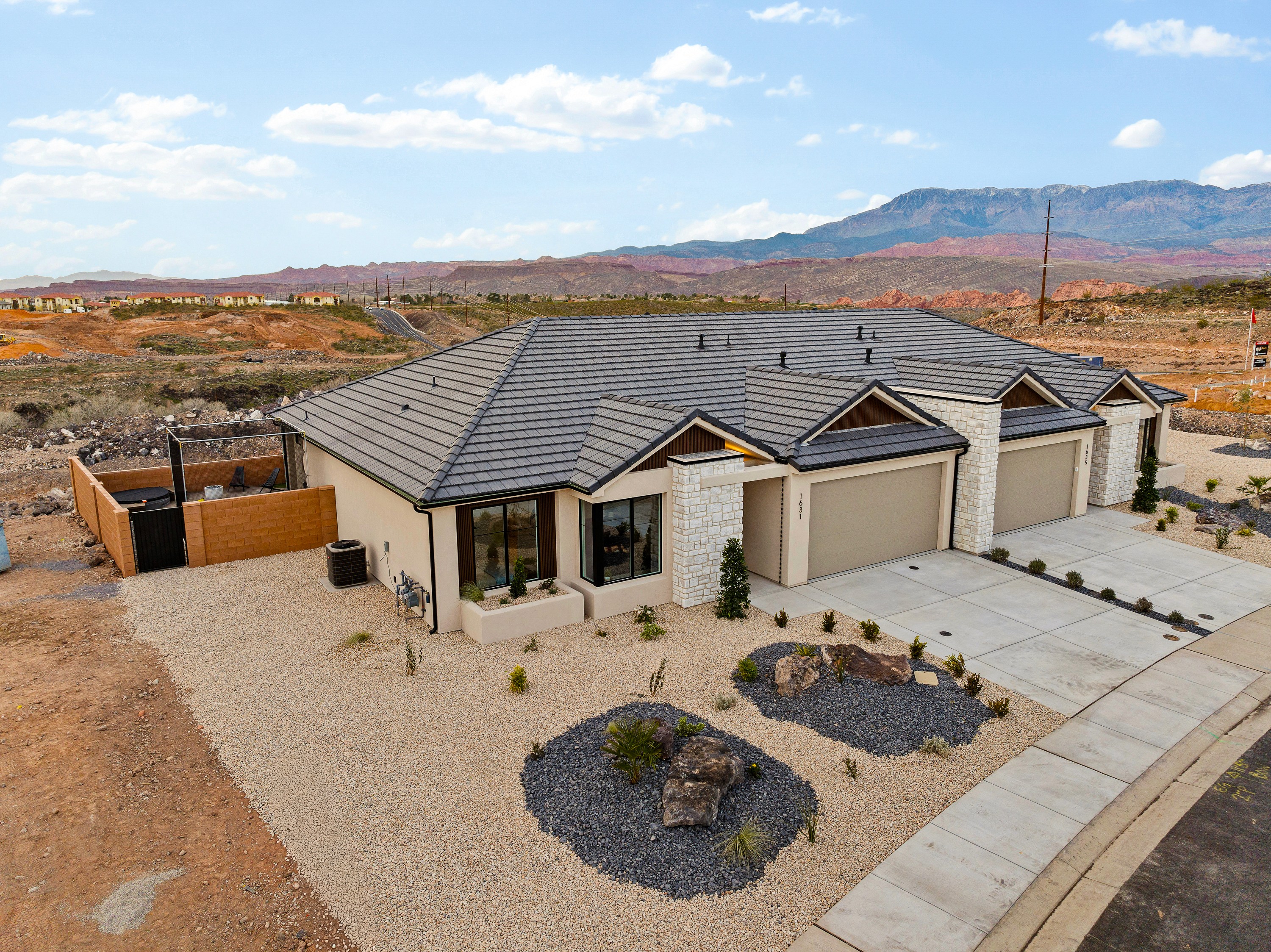 Aerial view of the front of The Painted Horizon twin home in Hurricane, Utah showcasing the elevated front elevation and surrounding neighborhood.