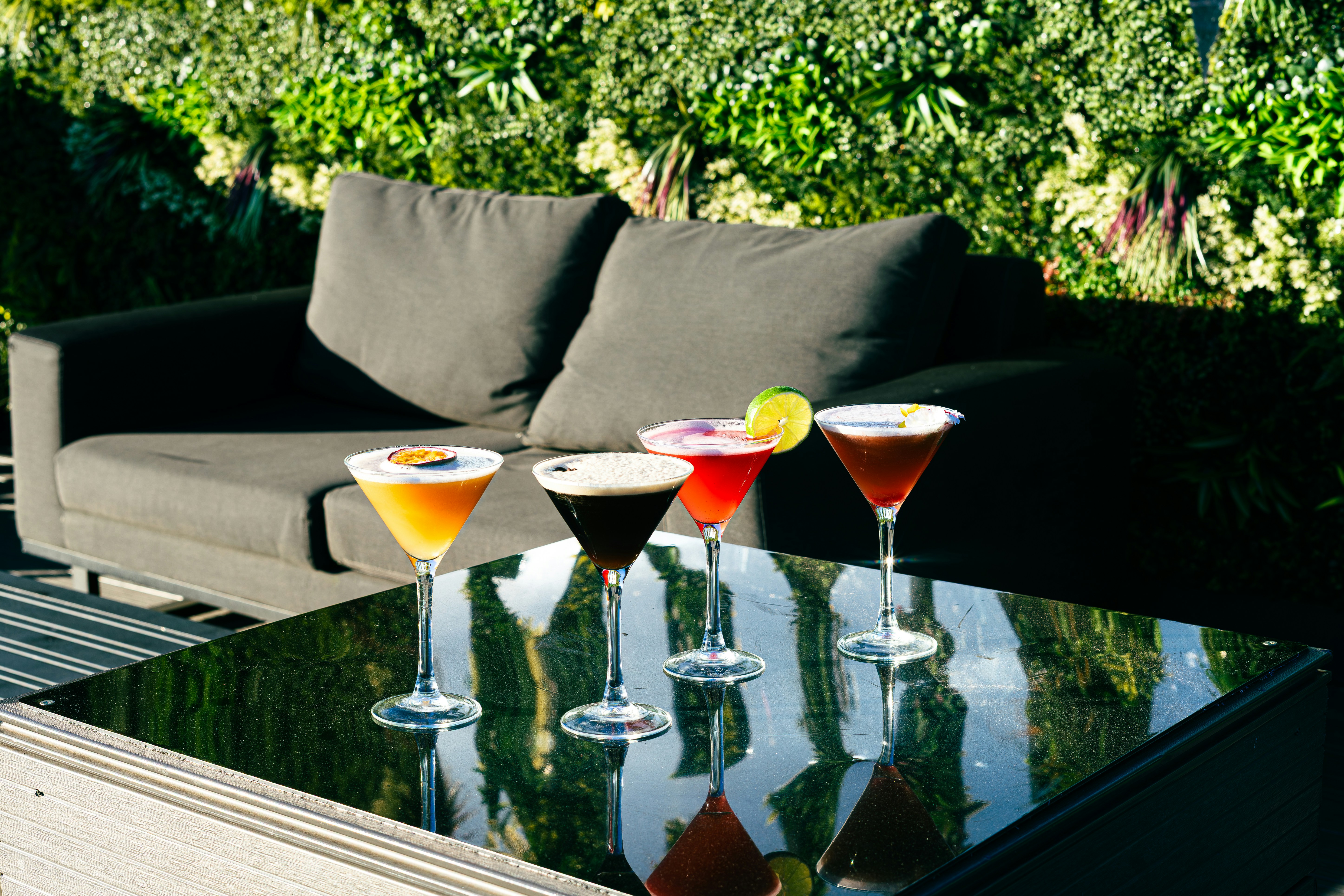 Hotel outdoor lounge with alcoholic drinks on a table.