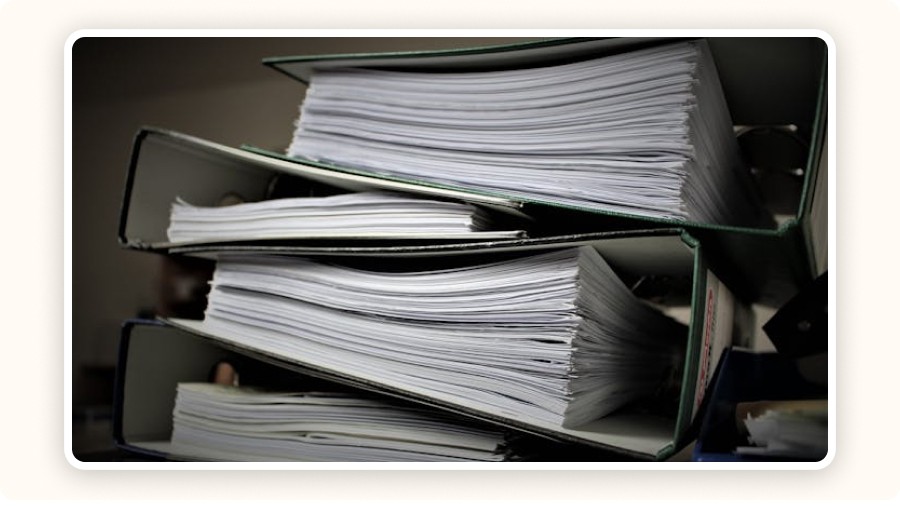 Stacked binders filled with documents