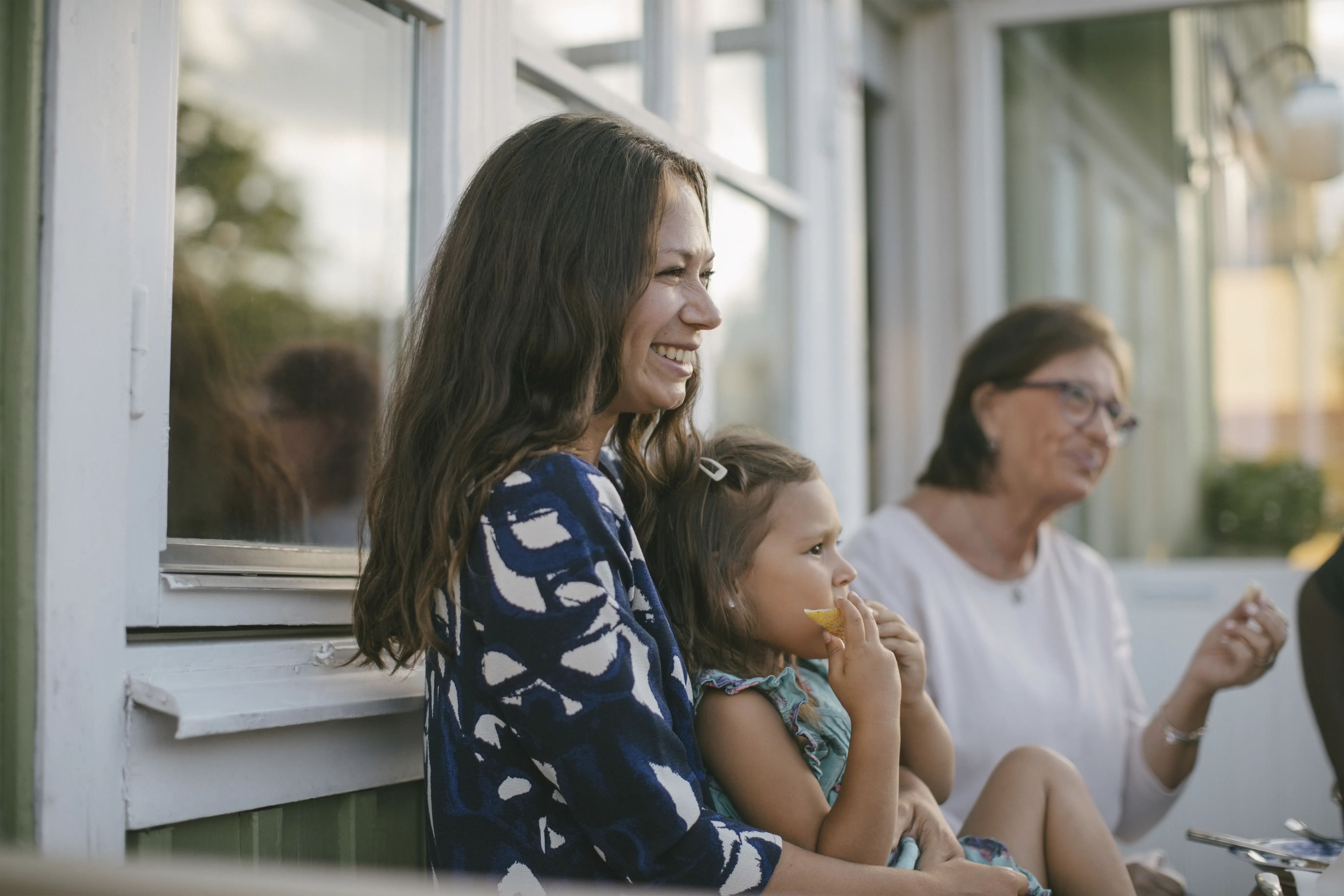 Woman holding baby smiling