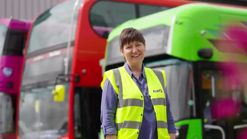 Group of presenters speaking on camera during a Microsoft live broadcast, filmed against branded event graphics.
