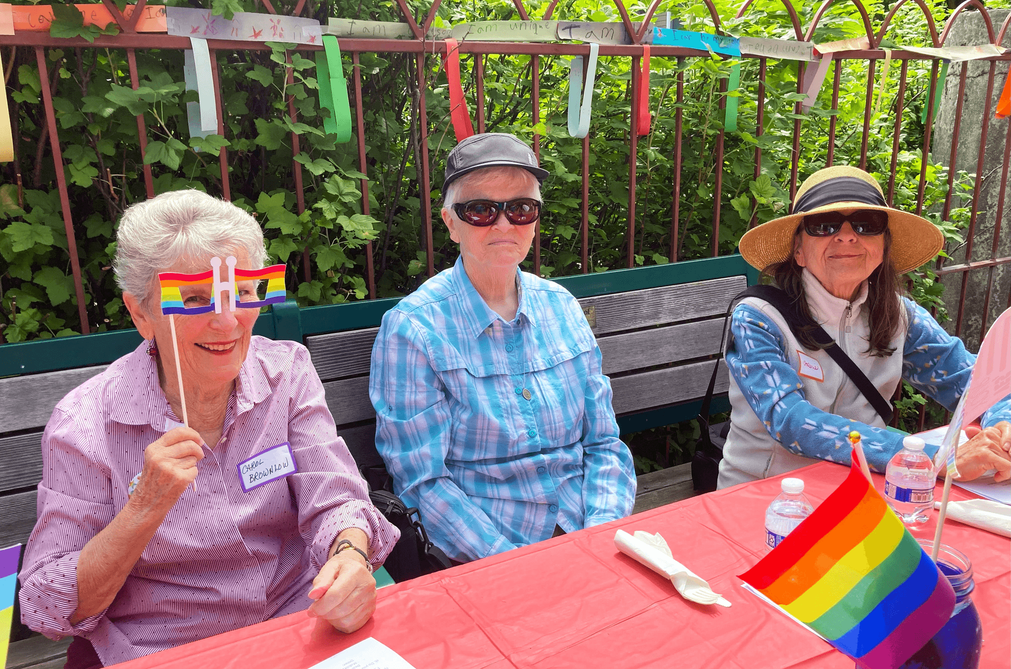 woman wearing yellow and pink floral dress wahing carrots