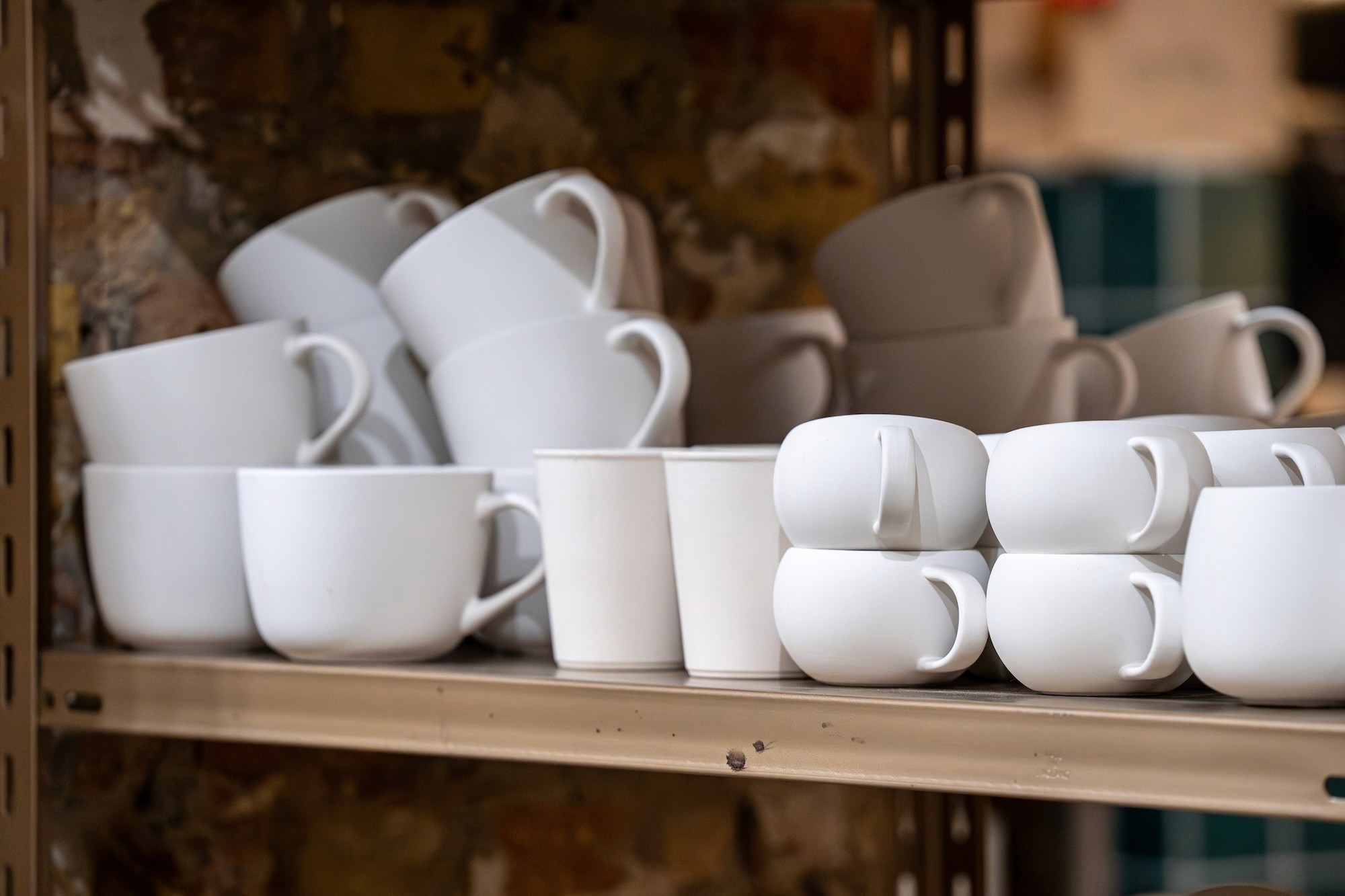 cups of various shapes ready to be painted by hand