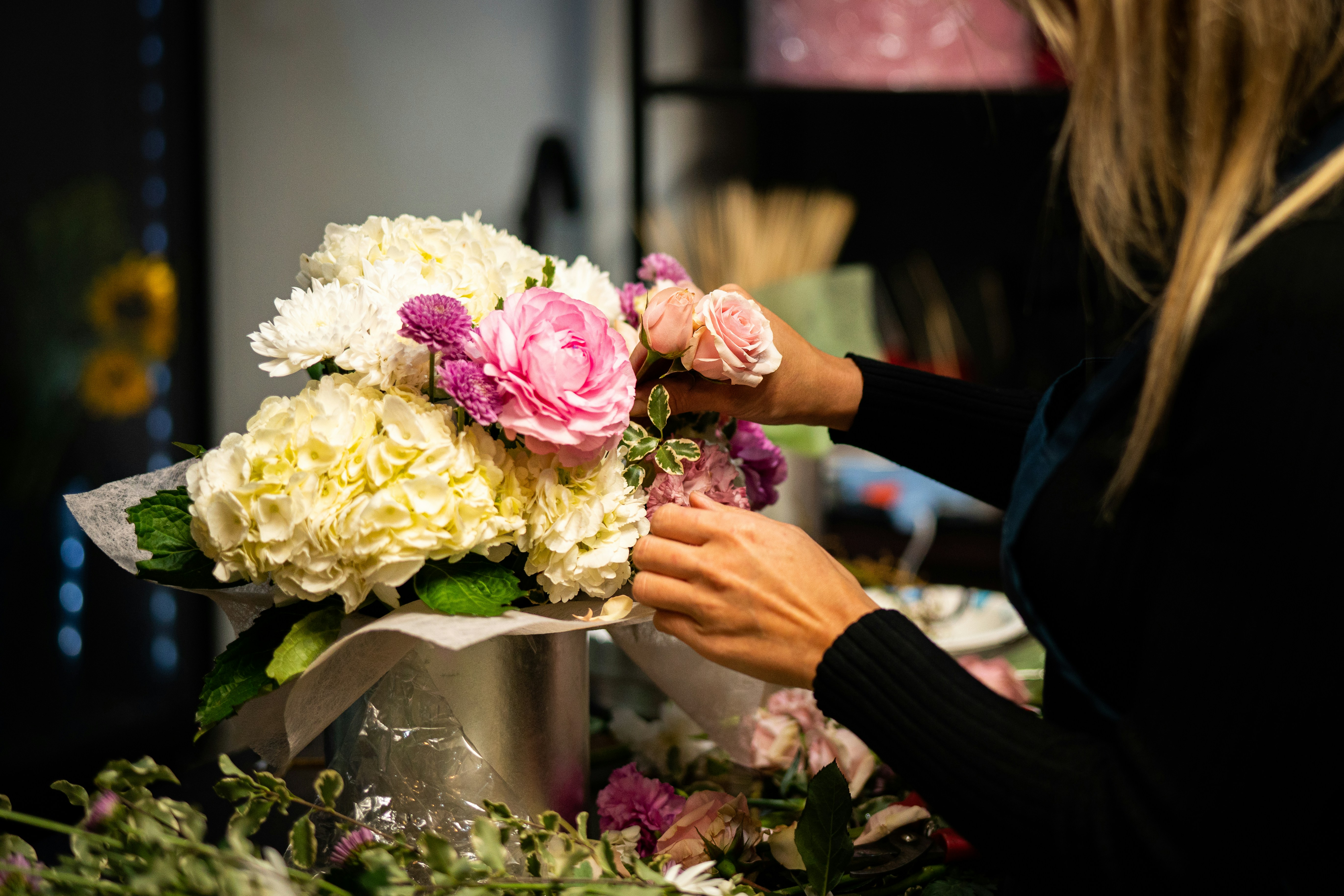 Florist arranging a wedding bouquet in a vase.