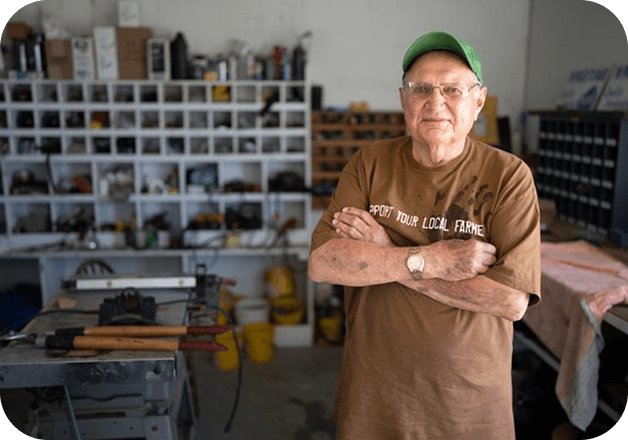 a man with arms crossed, smiling