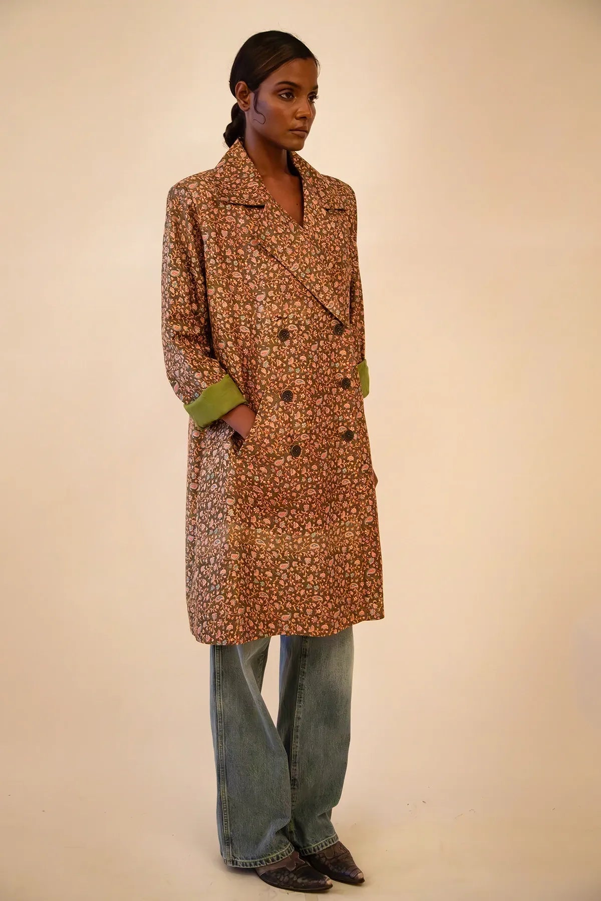 Ved is our one-of-a-kind paisley olive green silk trench coat, handcrafted by skilled artisans in-house using a vintage silk sari