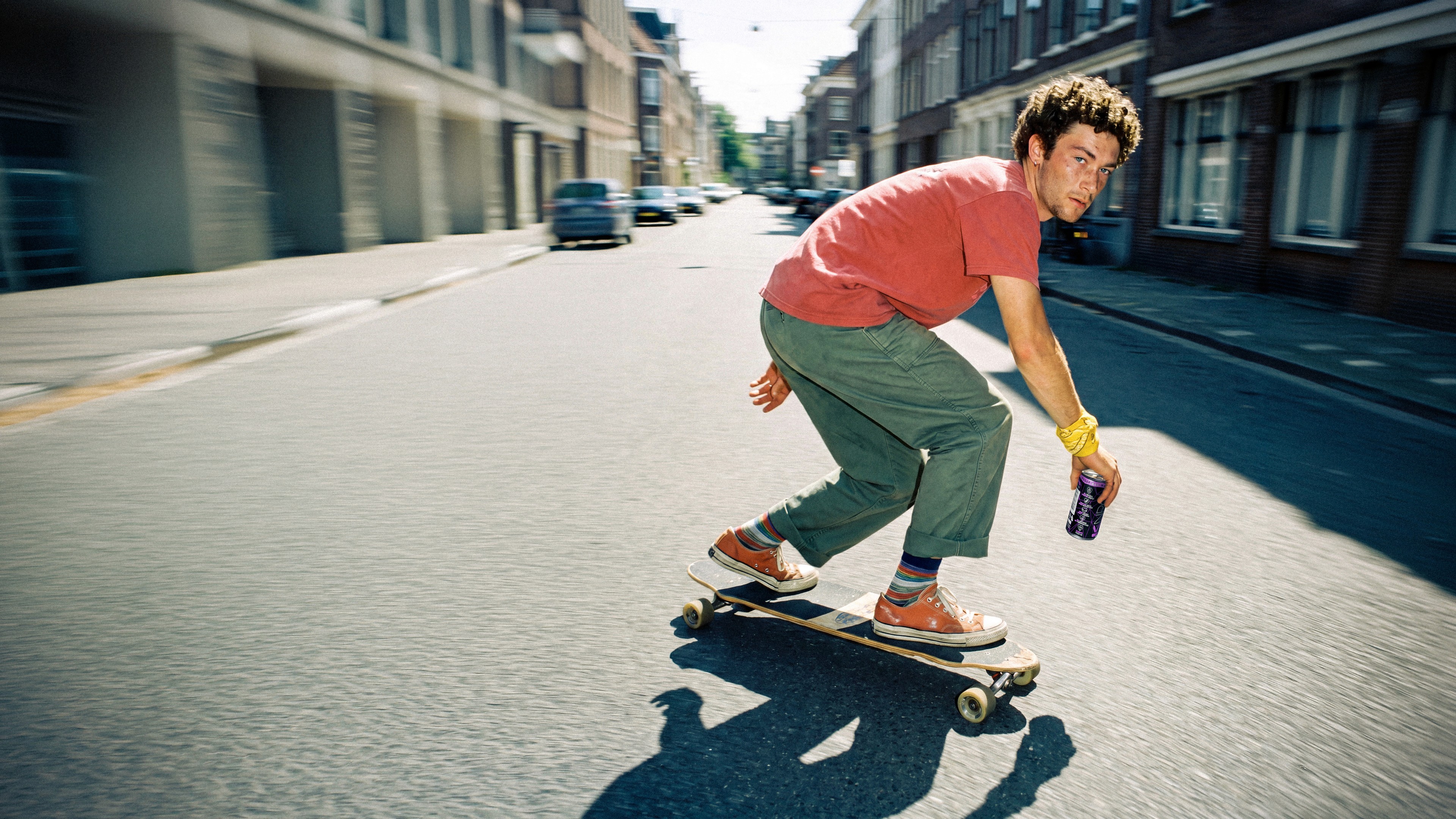 KNRG skate scene on a sunlit street.