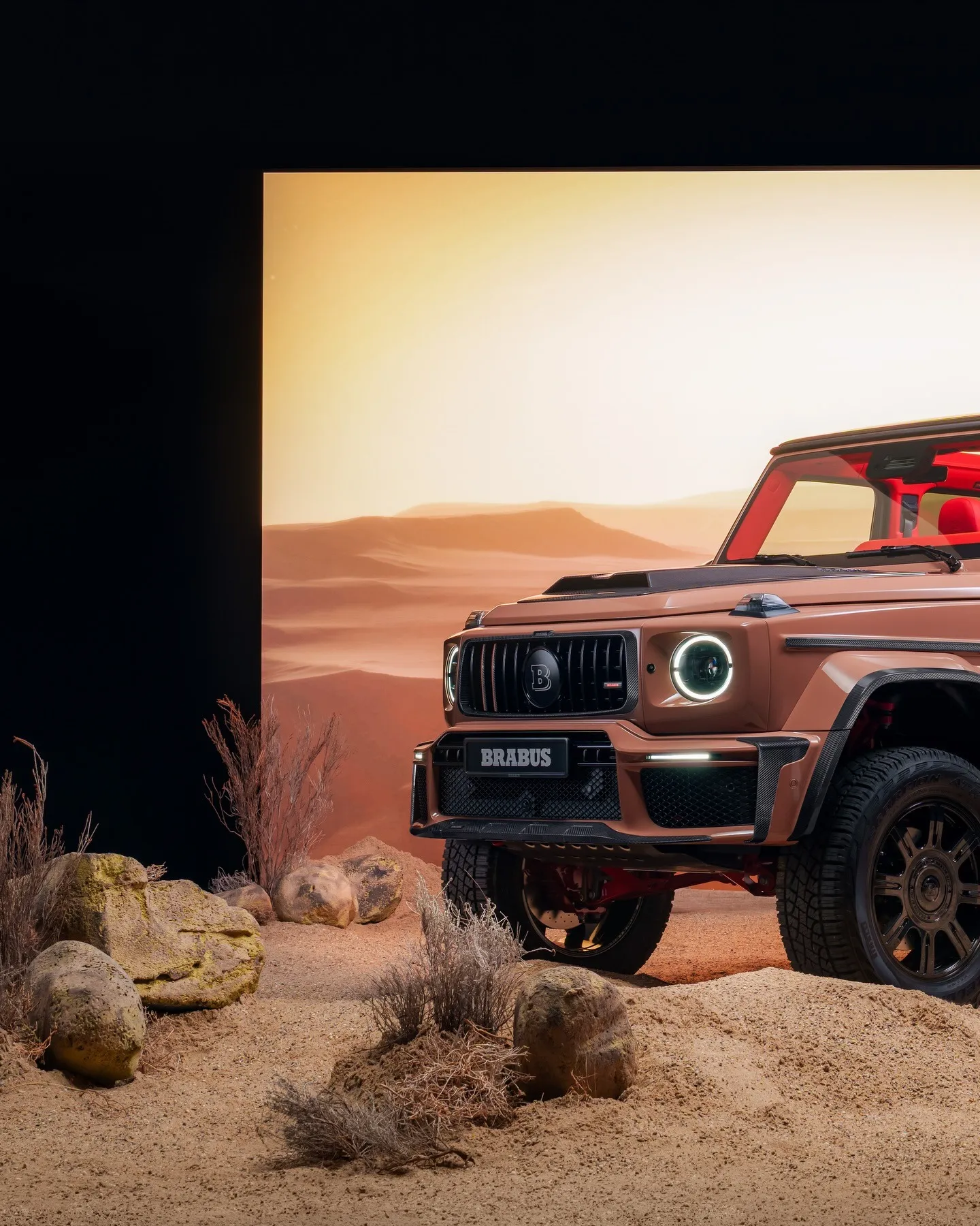 A young man in a white t-shirt stands against a light-colored background.