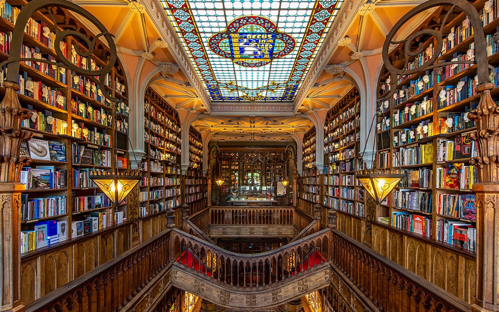 Lello Library interior with ornate wooden stairs and bookshelves, Porto, Portugal.