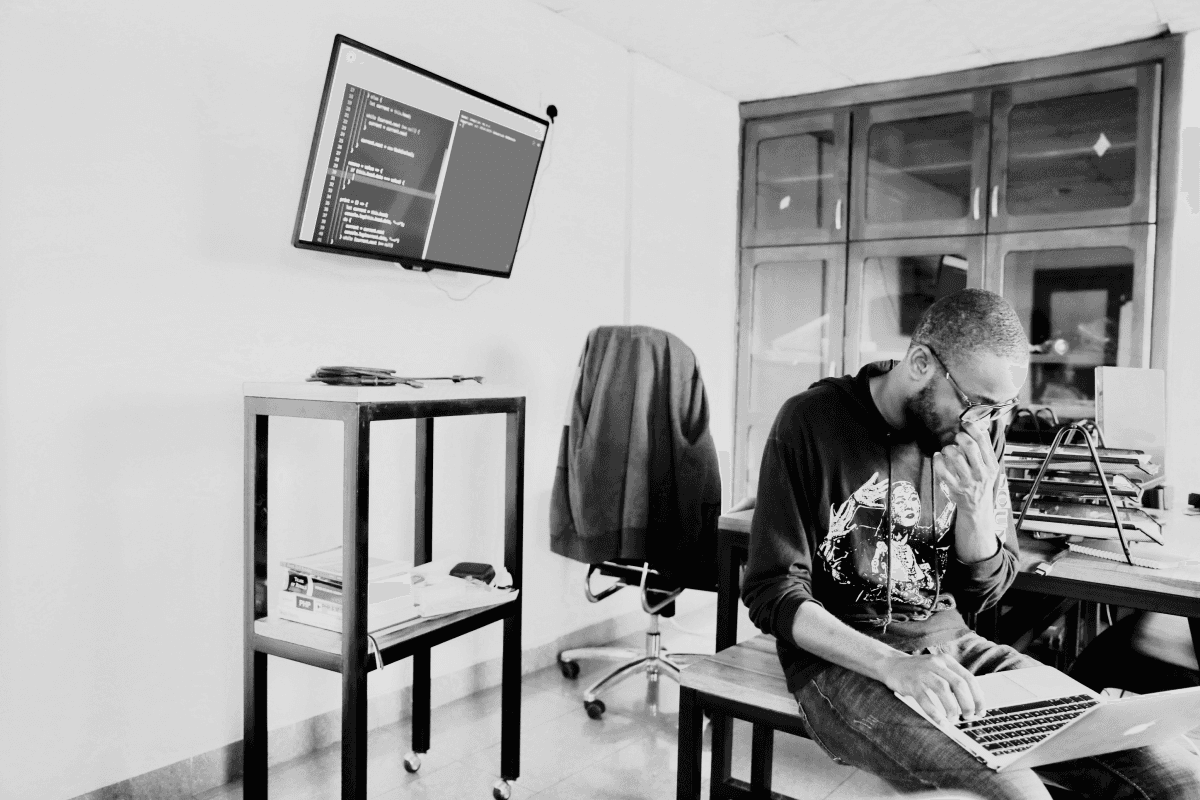 A man working on a laptop in an office. 