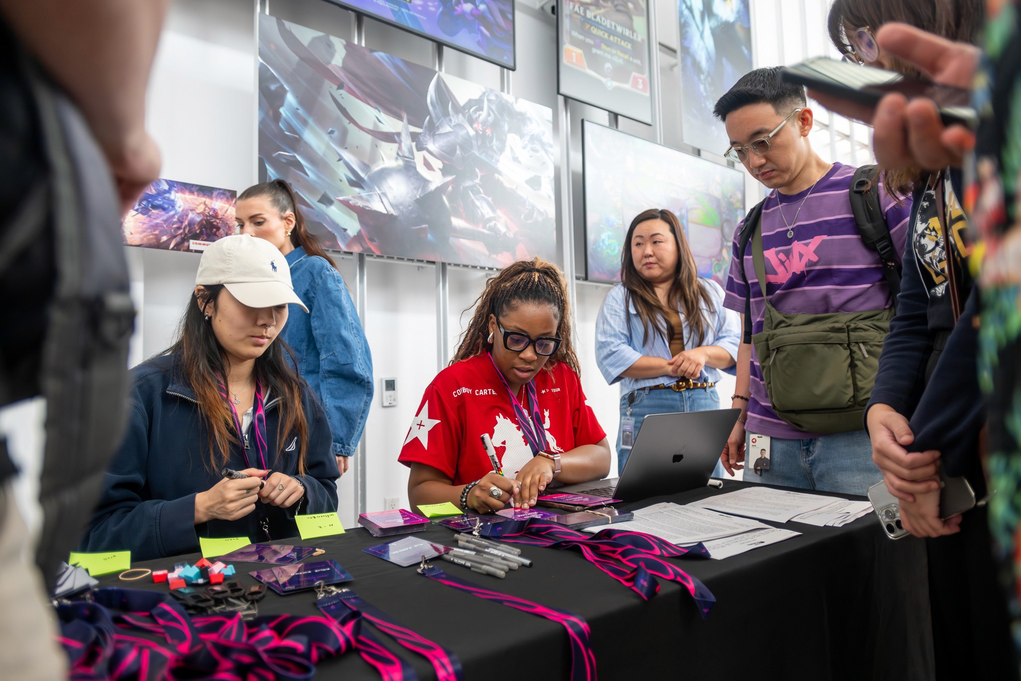 Gaming influencers networking and collaborating at a workstation during the summit.