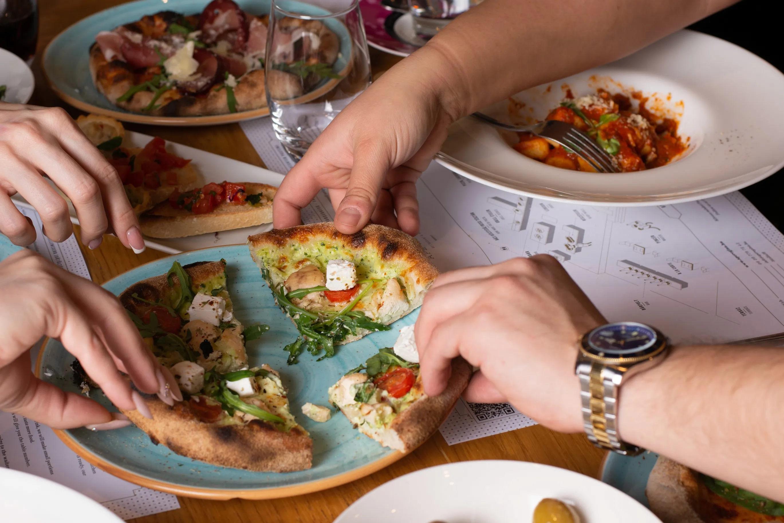 a group of people sitting at a long table