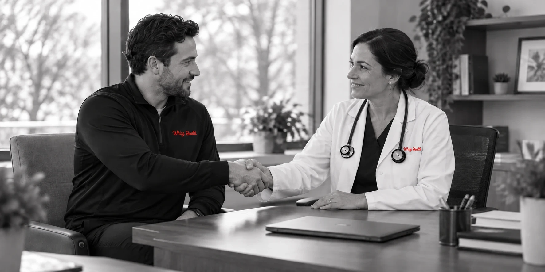 Whizz Health team member and physician shaking hands across a desk