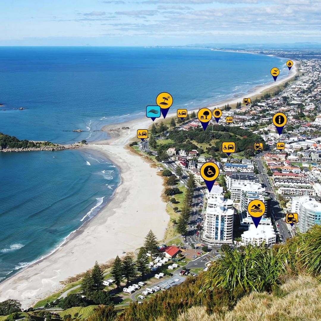 a photo of a coastal town with the ocean to the left and town displaying map pins on the right