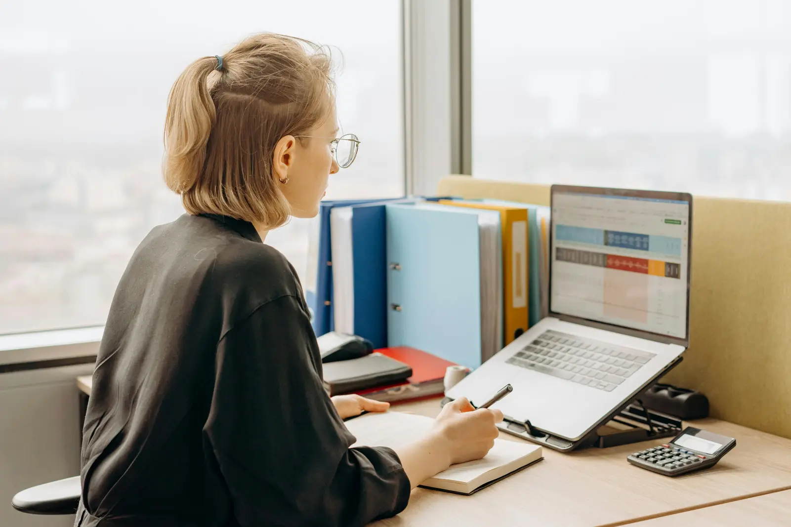 Woman on her computer working on something finance related.