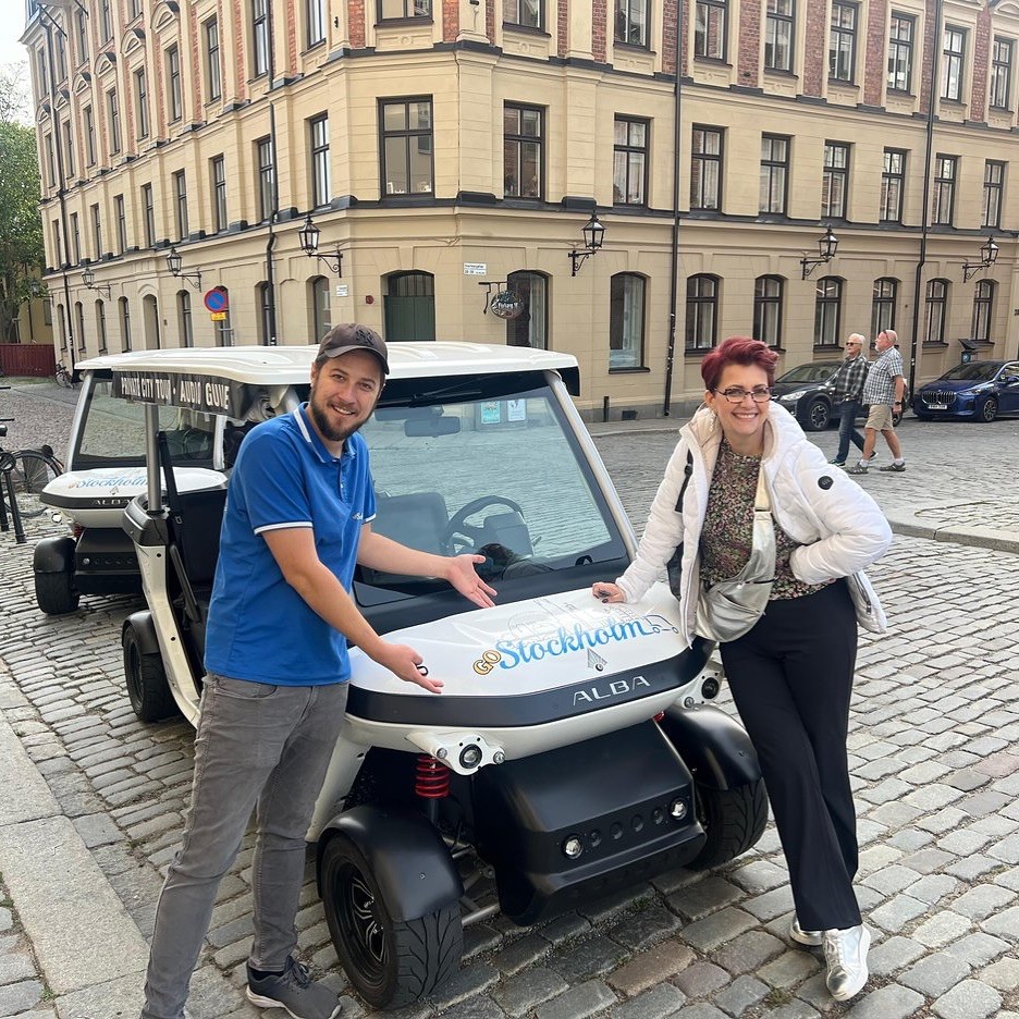 Tourists exploring Stockholm during private electric sightseeing cart tour