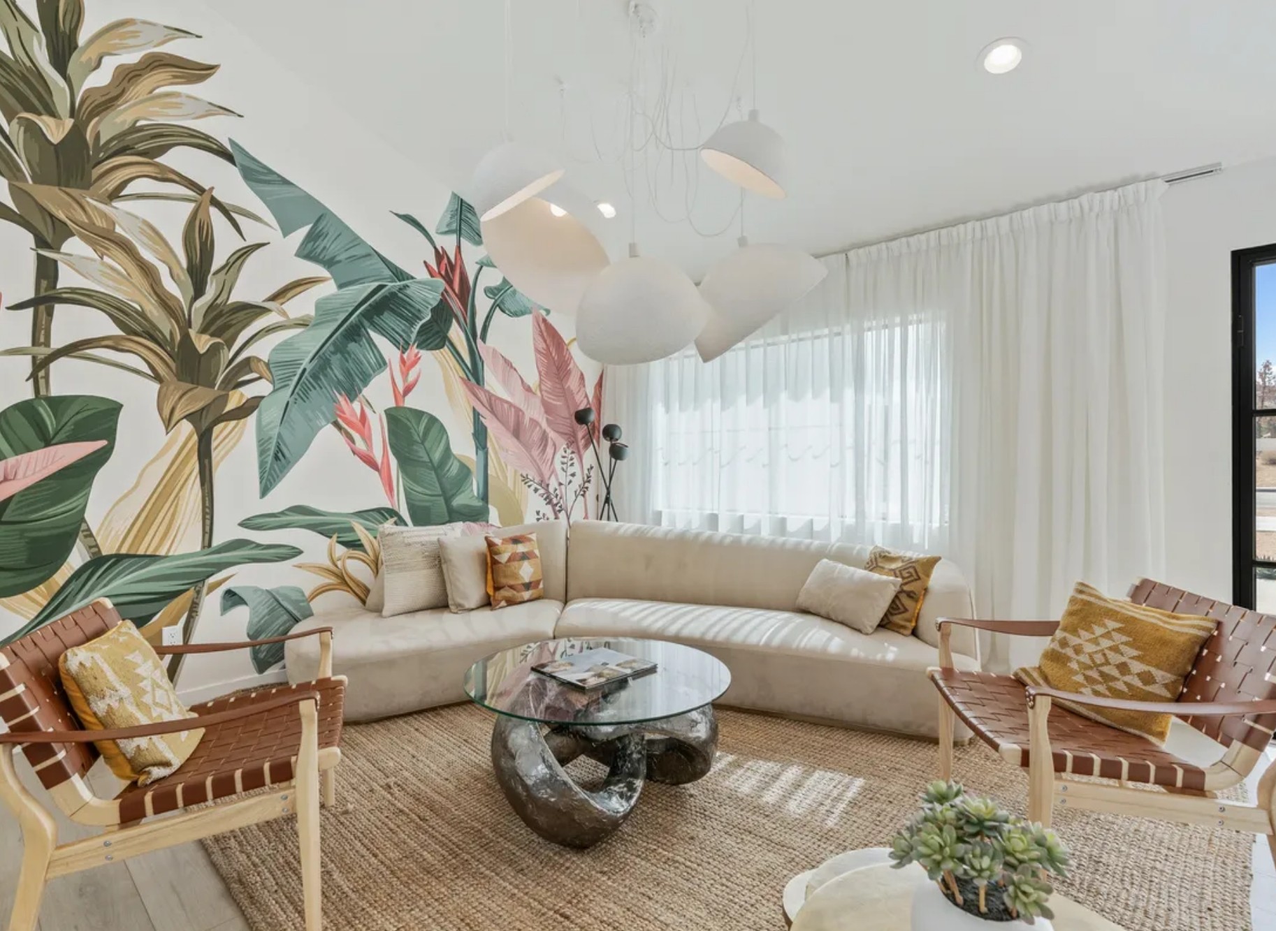 Close-up of a warm living space featuring a stone fireplace, a burnt orange accent chair with a striped pillow, a woven rug, and built-in shelves with decorative items