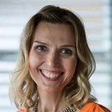 Professional headshot of Christine Le Maitre smiling warmly