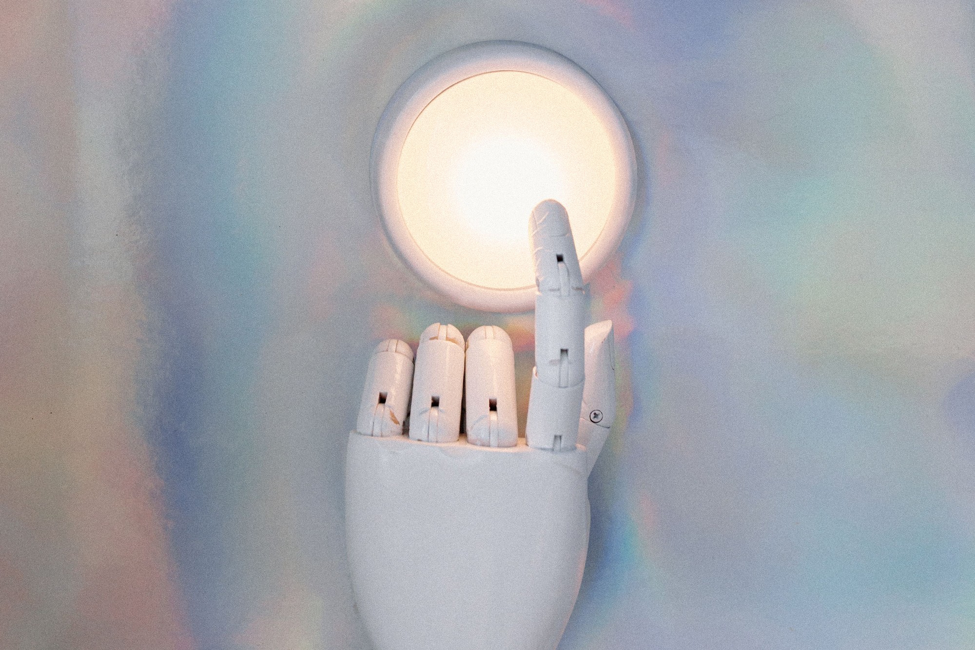 Robotic hand reaching toward light representing Claude AI capabilities for website development, SEO and business automation