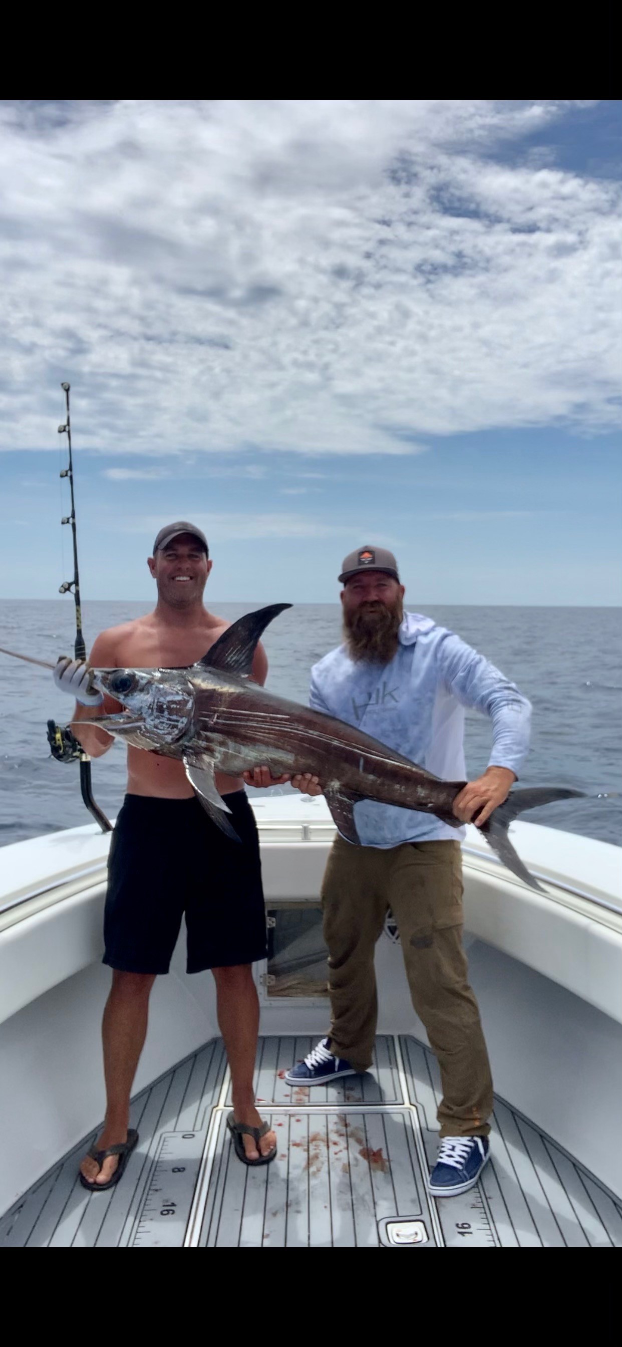 Men holding a Swordfish