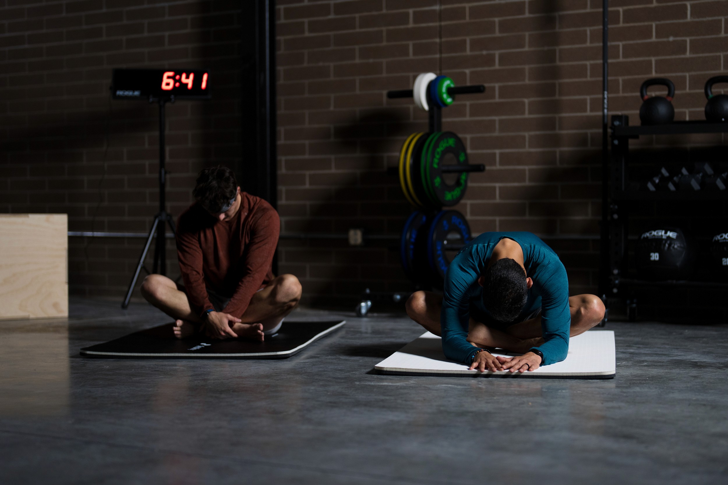 man stetching with his trainer - Seated Stretches
