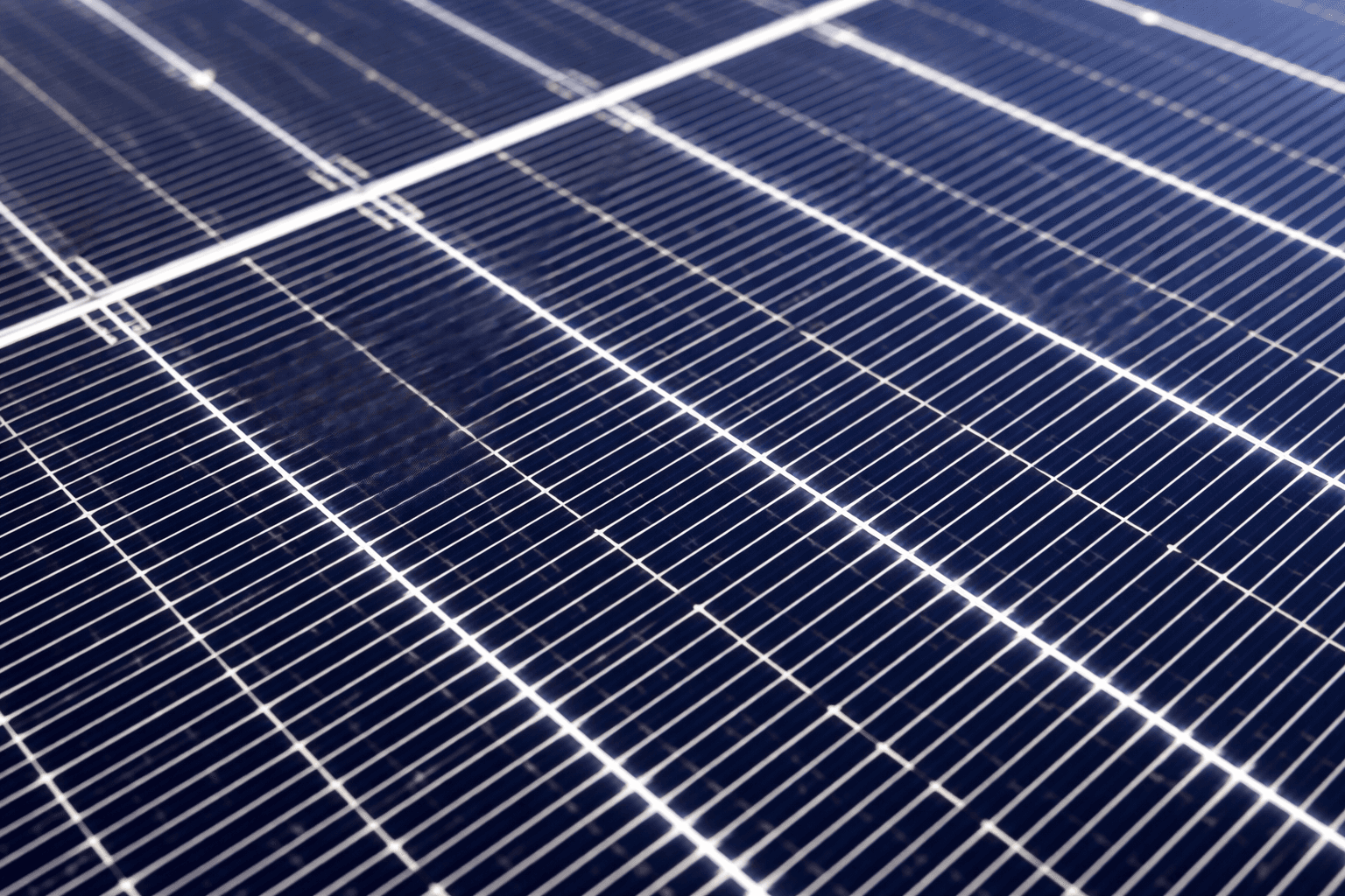 Close-up of photovoltaic solar panel surface showing solar cells and conductive grid lines