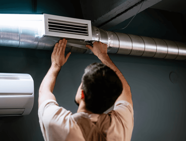 Technician inspecting and adjusting residential ductwork system in Toronto for improved airflow and indoor air quality.