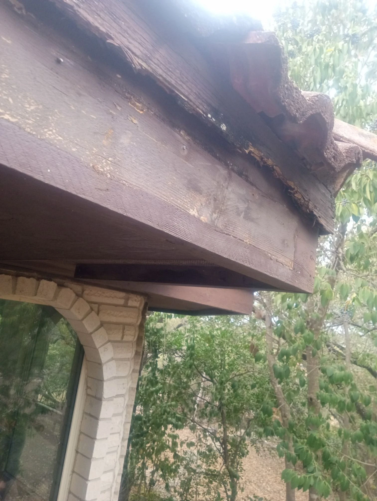 Before repair: fascia repair beneath a tile roof in Helotes, Texas.