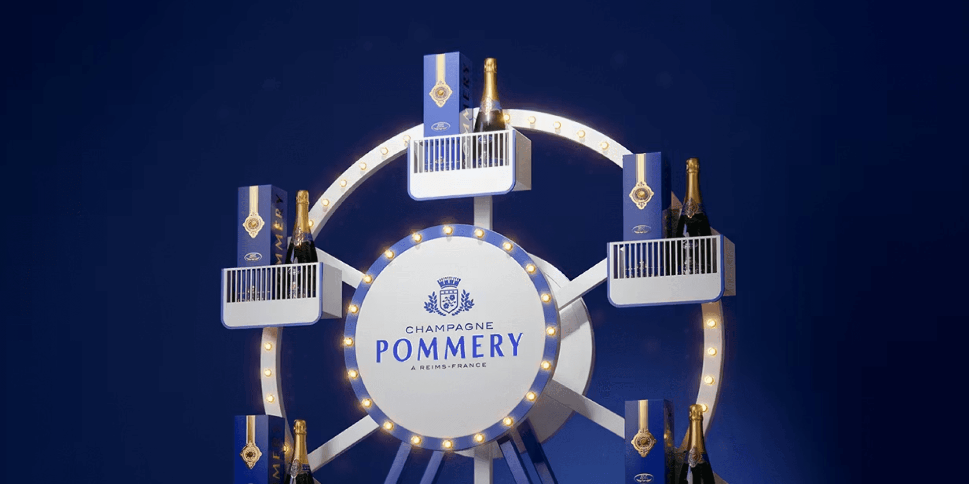 The brand world of Vranken-Pommery – Pommery Ferris wheel display with champagne bottles in the gondolas, against a deep blue background.