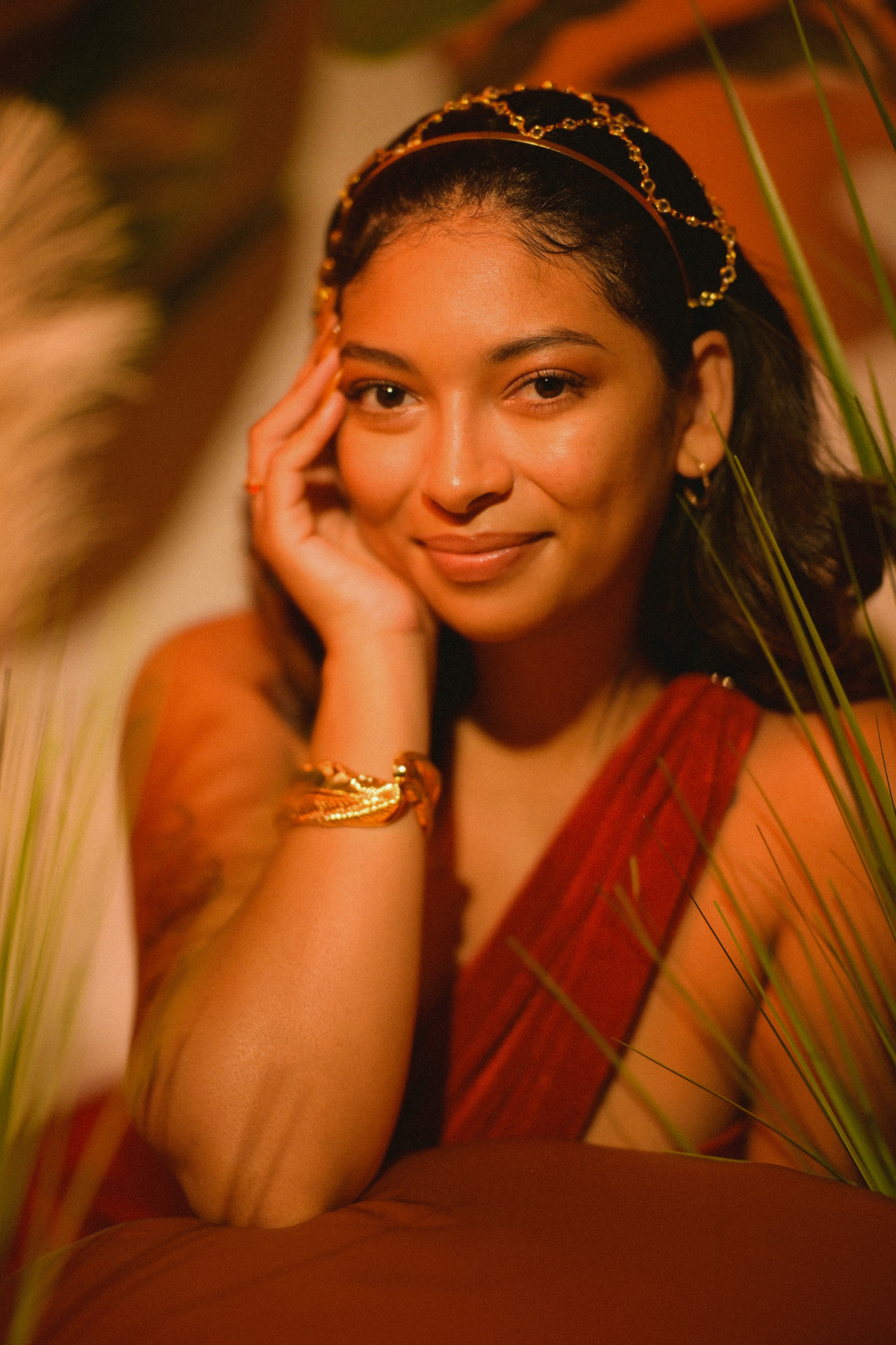 Woman with red hair wearing a white turtle neck sweater and white cowboy hat looking at herself in the mirror with her hand slight raised to her shoulder