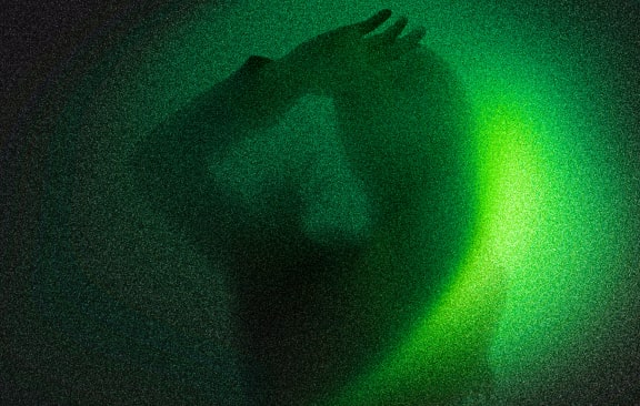 a person riding a snowboard on top of a sandy hill