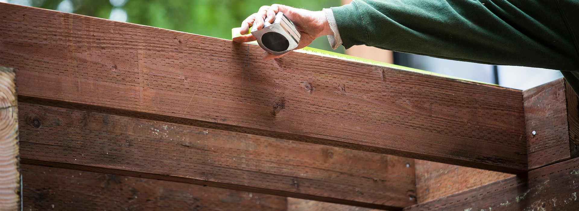Flat-lay of curated material samples including stone tiles, textured fabrics, ceramics, and botanicals arranged on a neutral surface.
