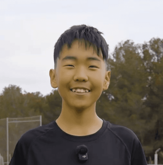 a woman sitting on a white chair next to a table