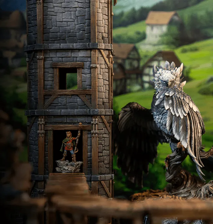 A mini house in the background with two miniatures close to each other