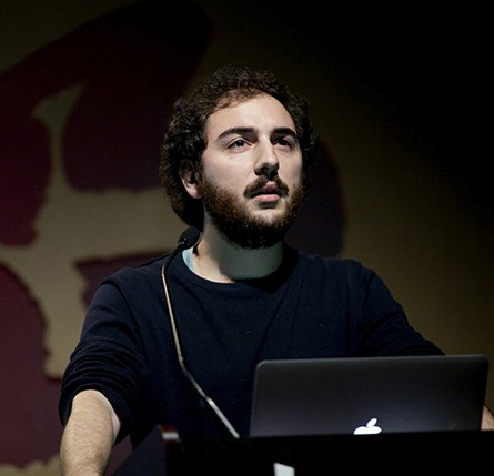 a man giving a speech at a stand